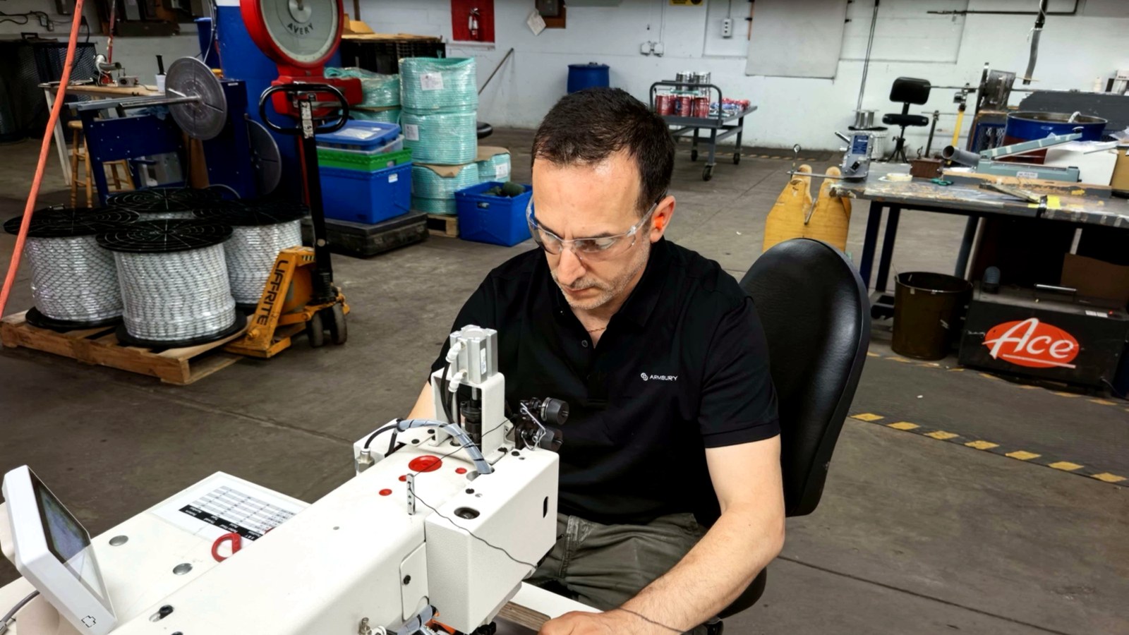 ARMBURY sewing technician bar-tacking a kernmantel rope termination on the manufacturing floor